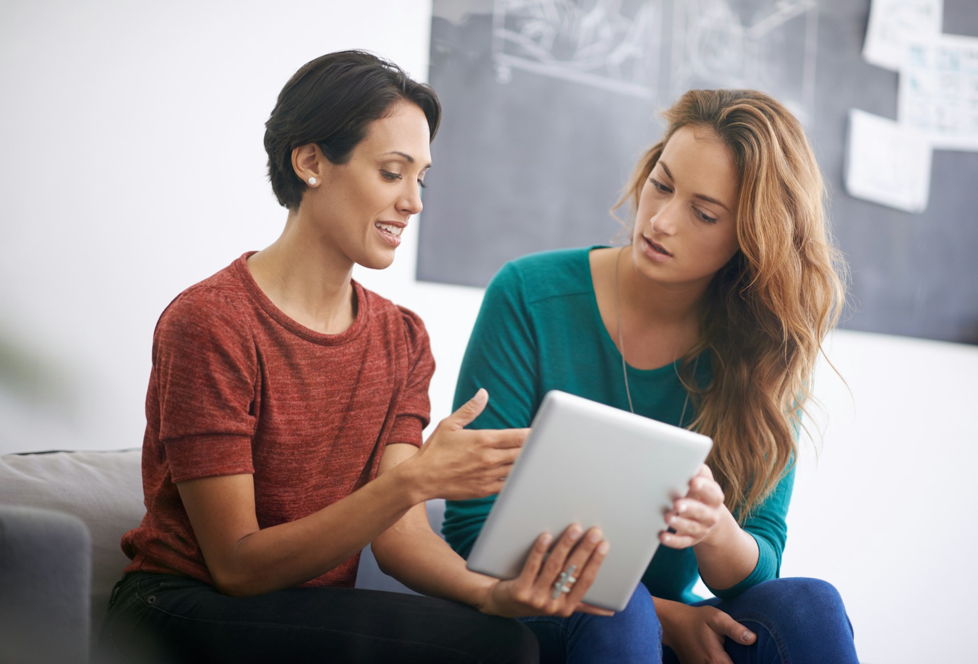 These designs are really good. Cropped shot of two female coworkers using a digital tablet.